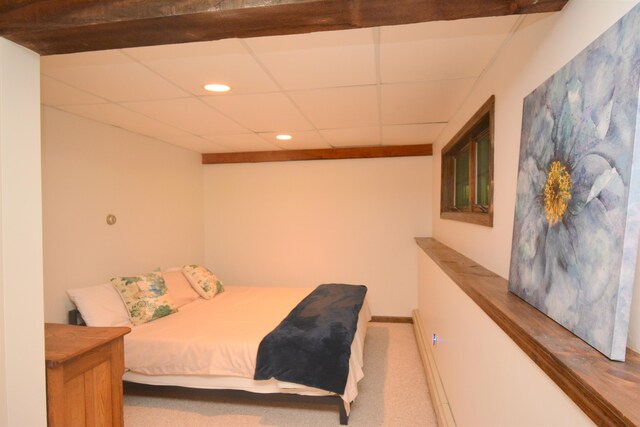 bedroom with carpet and a paneled ceiling