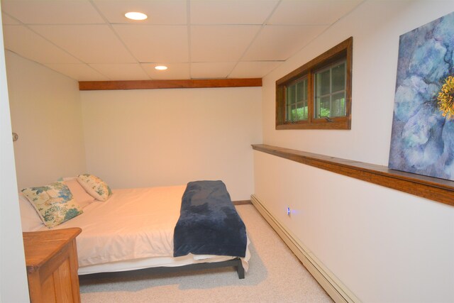 bedroom with a paneled ceiling and carpet flooring