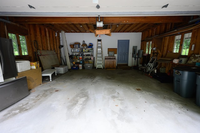 garage featuring wood walls and electric panel