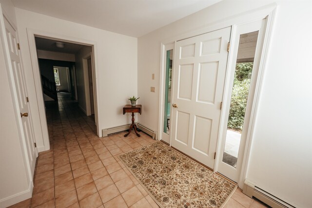 tiled foyer entrance featuring baseboard heating