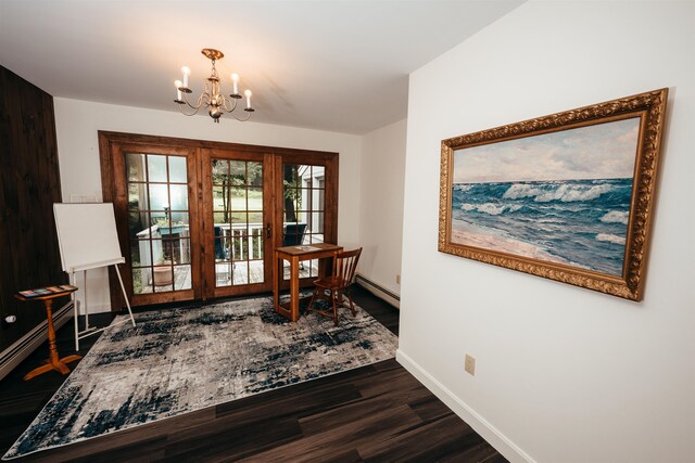 living area with a baseboard heating unit, a chandelier, and dark hardwood / wood-style floors