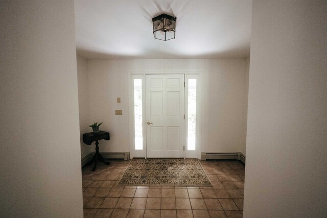 tiled foyer entrance with a baseboard radiator