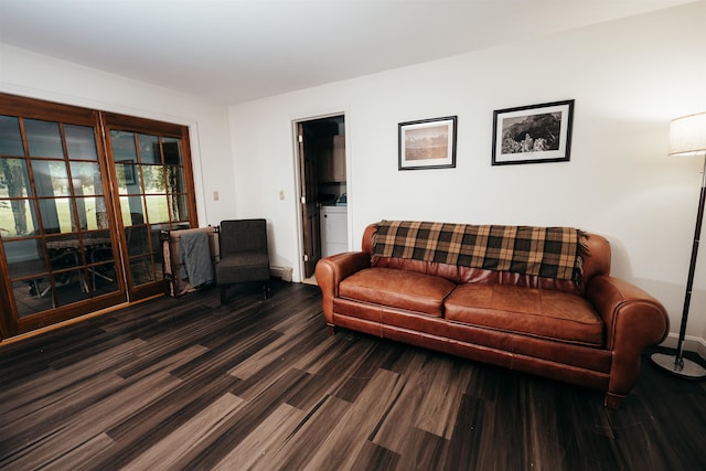 living room featuring washer / clothes dryer and dark hardwood / wood-style floors