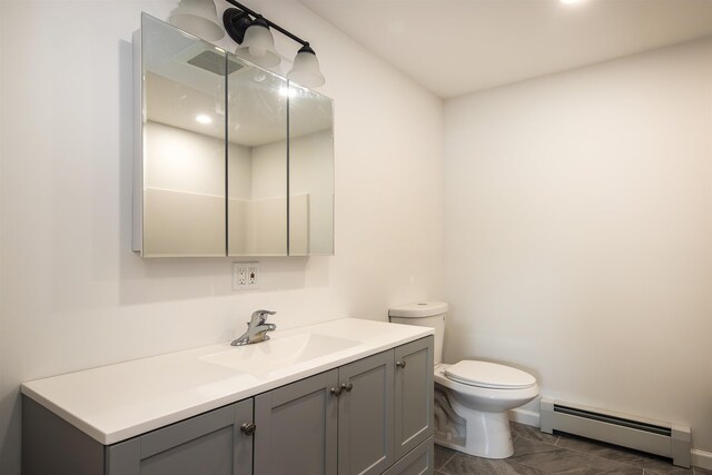 bathroom featuring marble finish floor, toilet, a baseboard heating unit, vanity, and baseboards