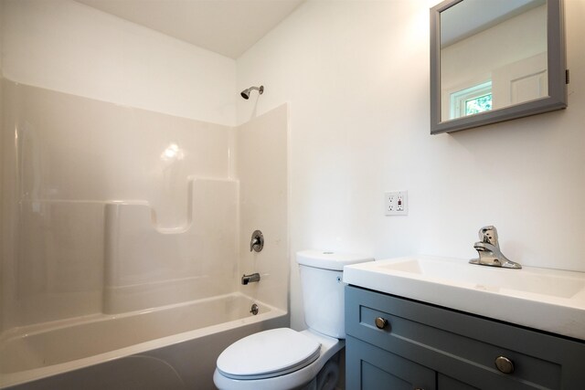 bathroom with tub / shower combination, vanity, and toilet