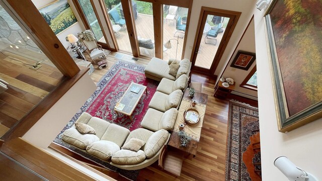 living room featuring ceiling fan, dark hardwood / wood-style floors, and baseboard heating