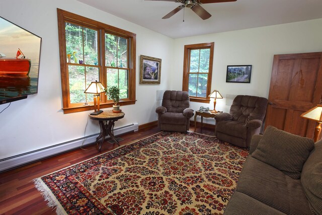 living room featuring dark hardwood / wood-style flooring, ceiling fan, and baseboard heating