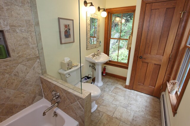 carpeted bedroom featuring ornamental molding, ceiling fan, and baseboard heating