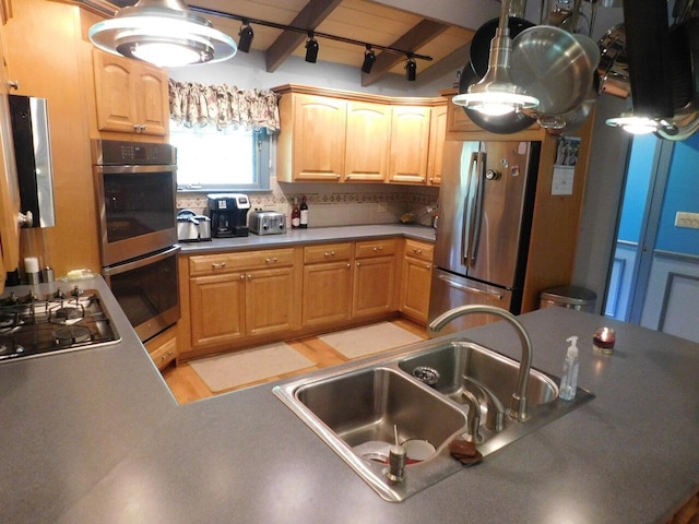 kitchen with sink, beam ceiling, stainless steel appliances, tasteful backsplash, and light brown cabinetry