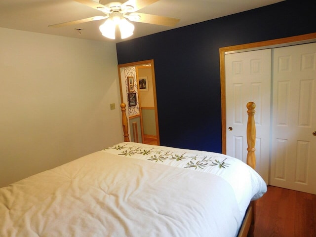 bedroom featuring hardwood / wood-style flooring, ceiling fan, and a closet