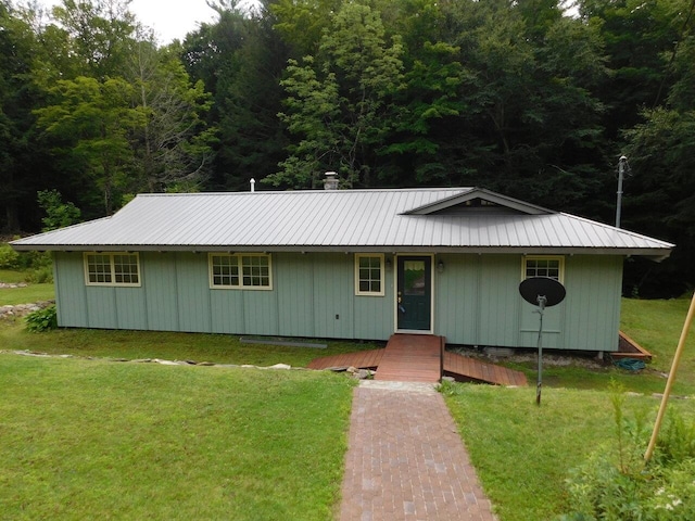 1012 Mountain Rd, Montgomery, VT 05471 - single story home with a forest view, a porch, a front yard, and metal roof