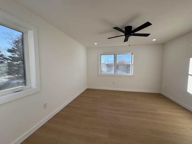 spare room with light wood-style floors, ceiling fan, baseboards, and recessed lighting