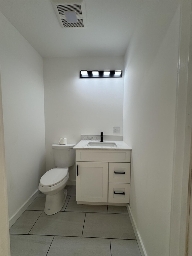 half bathroom with toilet, baseboards, visible vents, and vanity