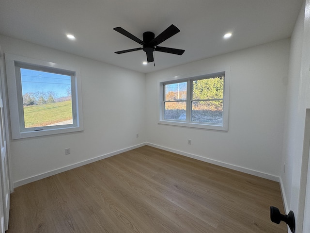 unfurnished room featuring a ceiling fan, recessed lighting, baseboards, and wood finished floors