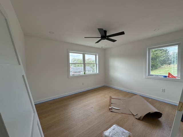 unfurnished bedroom with a ceiling fan, baseboards, and wood finished floors