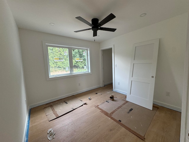 unfurnished bedroom with ceiling fan and light hardwood / wood-style flooring