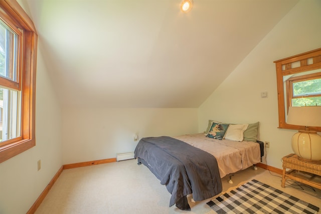 carpeted bedroom featuring baseboard heating and vaulted ceiling