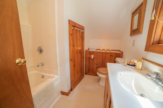 bathroom with toilet, vanity, and lofted ceiling