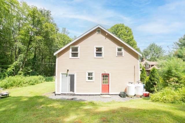 back of property featuring a yard