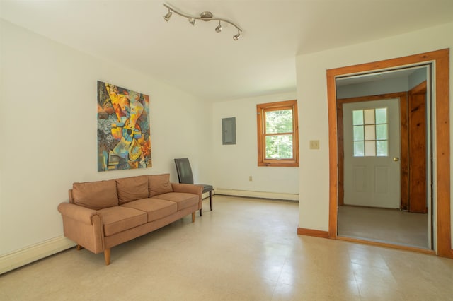 living room with a baseboard radiator and electric panel