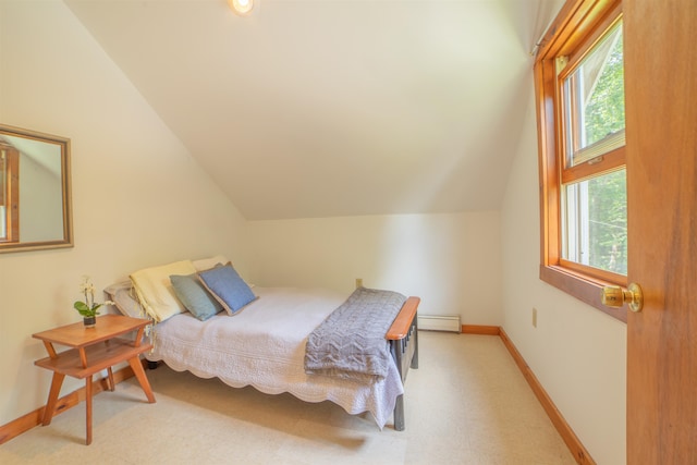 bedroom with lofted ceiling and baseboard heating