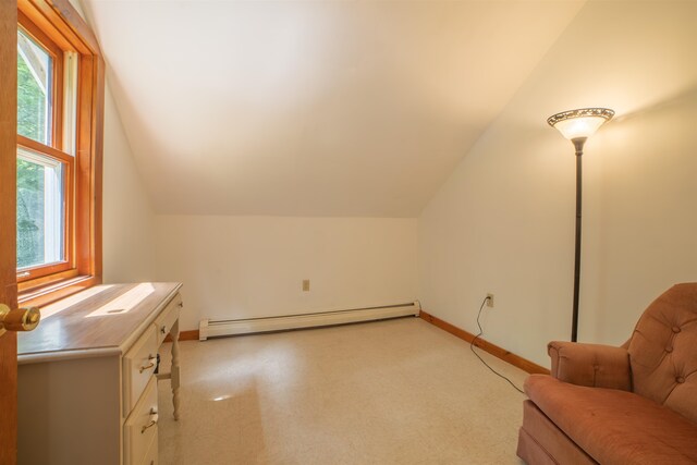 bonus room featuring a baseboard heating unit and vaulted ceiling