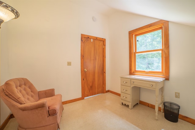 sitting room featuring lofted ceiling and light colored carpet