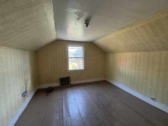 bonus room featuring baseboards, wood-type flooring, lofted ceiling, and wallpapered walls