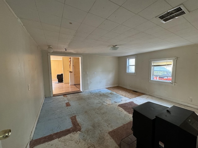 unfurnished room with visible vents and baseboards