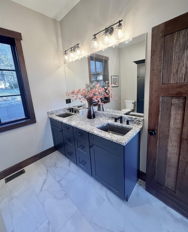 bathroom with vanity and toilet