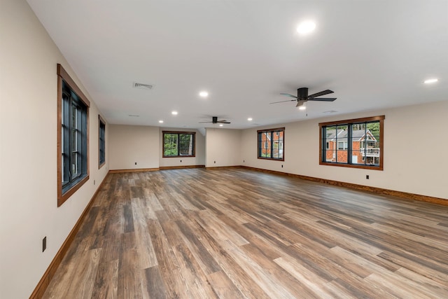 unfurnished living room featuring wood-type flooring and ceiling fan