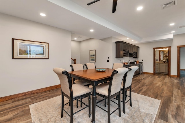 dining space featuring dark wood-type flooring and ceiling fan