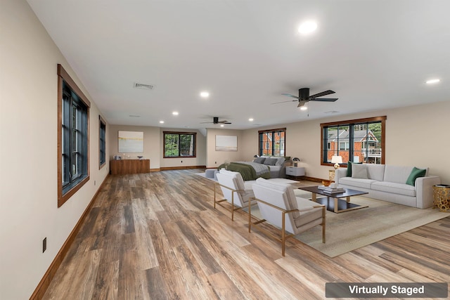 living room featuring hardwood / wood-style flooring, plenty of natural light, and ceiling fan