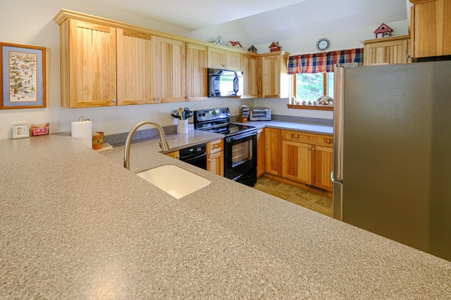 kitchen featuring lofted ceiling, light countertops, a sink, and black appliances