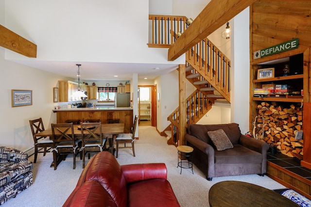 living area featuring light colored carpet and stairway