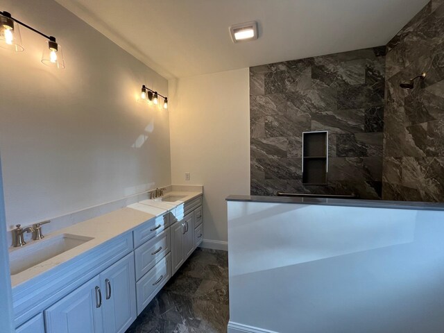 bathroom featuring tiled shower, tile patterned flooring, and double sink vanity