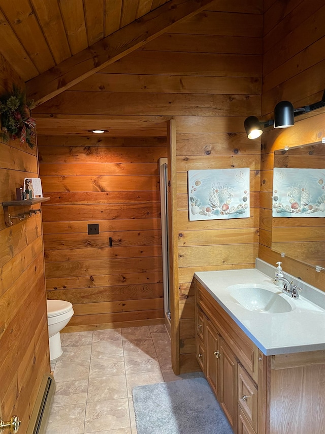 full bathroom with wooden walls, vanity, a stall shower, and toilet
