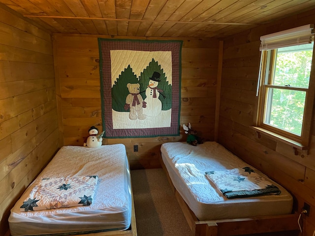 bedroom featuring wooden walls and wooden ceiling