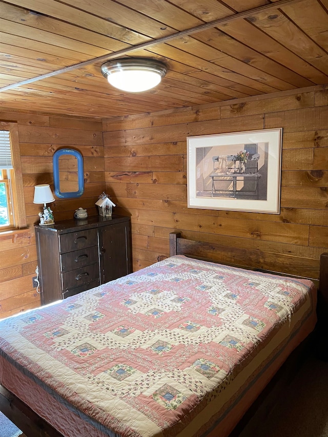 bedroom with wooden walls and wooden ceiling