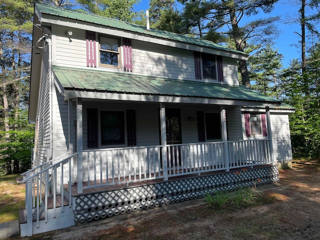 view of front of property featuring a porch and metal roof