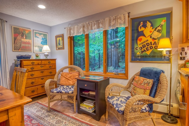 sitting room with a baseboard radiator and a textured ceiling