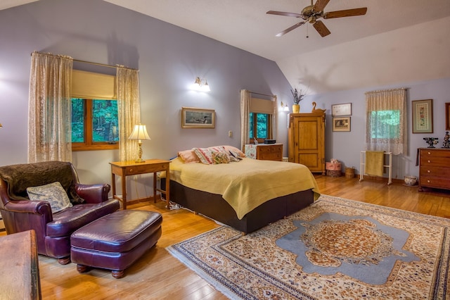 bedroom with hardwood / wood-style flooring and lofted ceiling