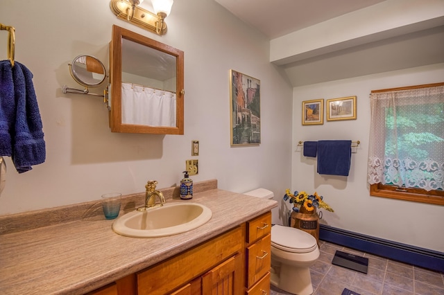 bathroom with vanity, toilet, and tile patterned flooring