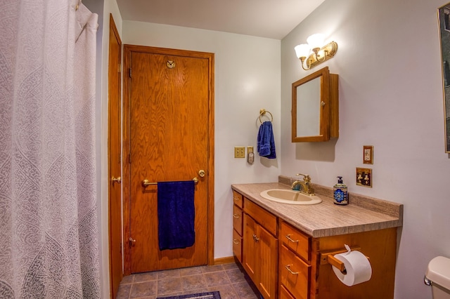 bathroom featuring vanity, toilet, and tile patterned flooring