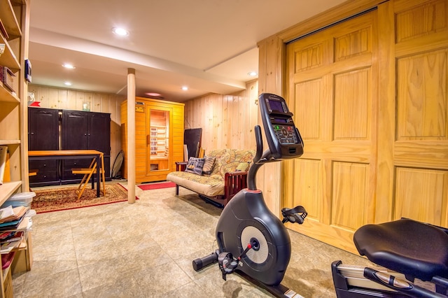 exercise room featuring wooden walls