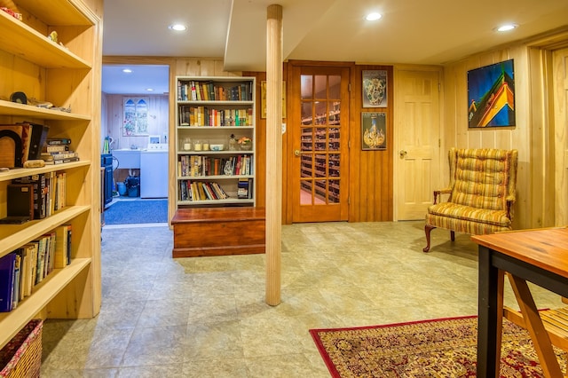 sitting room featuring wooden walls