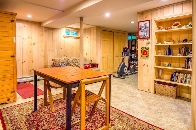 dining room with built in shelves and wood walls