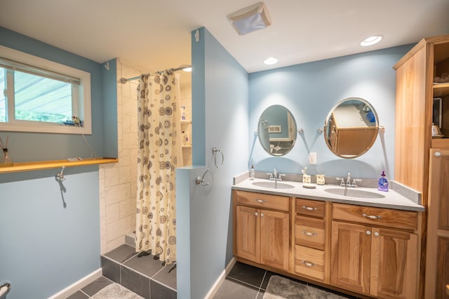 bathroom with tile patterned floors and dual bowl vanity