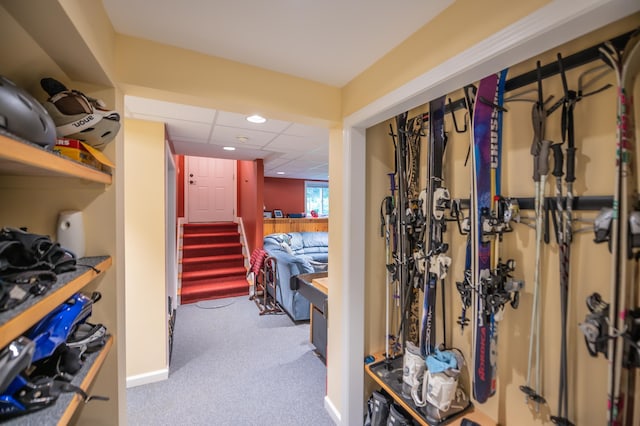 walk in closet with a drop ceiling and carpet floors