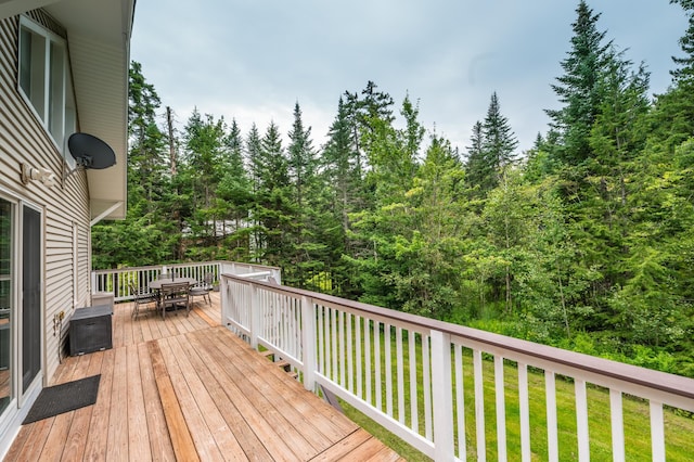 wooden terrace featuring a lawn